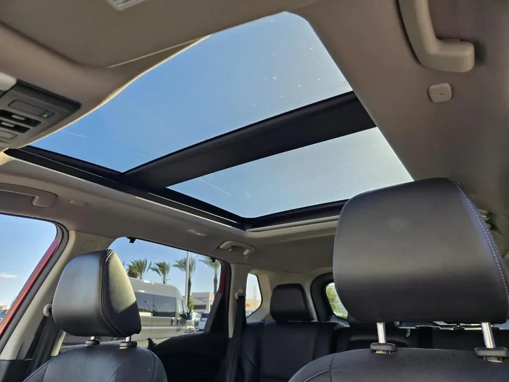 A bright and airy cabin of a Nissan Rogue equipped with a panoramic moonroof